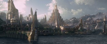 Movie still from “Thor: Ragnarok” (2017), directed by Taika Waititi – An artistic rendering of a city with a mountain in the background; Extreme Wide shot, High angle