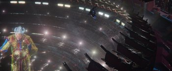 Movie still from “Thor: Ragnarok” (2017), directed by Taika Waititi – A man flying through the air while riding a snowboard; Extreme Wide shot, Overhead angle