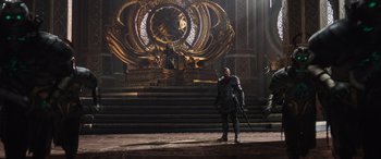 Movie still from “Thor: Ragnarok” (2017), directed by Taika Waititi – A man standing in front of a throne in a room; Wide shot, Low angle