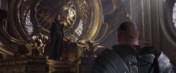 Movie still from “Thor: Ragnarok” (2017), directed by Taika Waititi – A woman standing on top of a stage in front of an audience; Medium shot, Over the shoulder angle