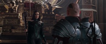 Movie still from “Thor: Ragnarok” (2017), directed by Taika Waititi – A woman and a man are standing next to each other in a room; Medium shot, Over the shoulder angle
