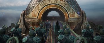 Movie still from “Thor: Ragnarok” (2017), directed by Taika Waititi – A group of people standing in front of an archway; Wide shot, High angle