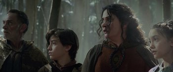 Movie still from “Thor: Ragnarok” (2017), directed by Taika Waititi – A woman and a young boy standing next to each other in front of trees; Close Up shot, Low angle