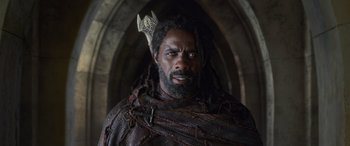 Movie still from “Thor: Ragnarok” (2017), directed by Taika Waititi – A man with dreadlocks wearing a crown; Close Up shot, Low angle