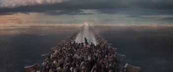 Movie still from “Thor: Ragnarok” (2017), directed by Taika Waititi – A crowd of people sitting on top of a boat in the ocean; Extreme Wide shot, High angle
