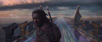 Movie still from “Thor: Ragnarok” (2017), directed by Taika Waititi – A man with a long beard and a long coat on; Medium shot, Low angle