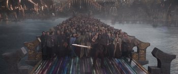 Movie still from “Thor: Ragnarok” (2017), directed by Taika Waititi – A large group of people standing in front of each other holding a sword; Extreme Wide shot, High angle
