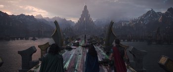 Movie still from “Thor: Ragnarok” (2017), directed by Taika Waititi – A group of people standing on top of a road; Extreme Wide shot, High angle