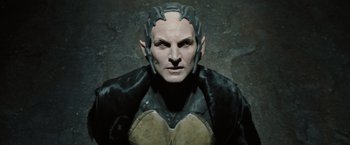 Movie still from “Thor: The Dark World” (2013), directed by Alan Taylor – A man in a black and gold costume; Close Up shot, High angle