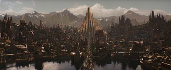 Movie still from “Thor: The Dark World” (2013), directed by Alan Taylor – An artistic rendering of a city with mountains in the background; Extreme Wide shot, High angle