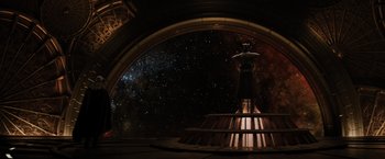 Movie still from “Thor: The Dark World” (2013), directed by Alan Taylor – An image of a woman standing in front of a space background; Extreme Wide shot, Low angle