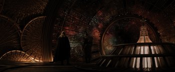 Movie still from “Thor: The Dark World” (2013), directed by Alan Taylor – Two people standing in a room with a space background; Extreme Wide shot, High angle