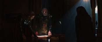 Movie still from “Thor: The Dark World” (2013), directed by Alan Taylor – A man and a woman are looking at a book; Medium shot, Over the shoulder angle