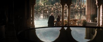 Movie still from “Thor: The Dark World” (2013), directed by Alan Taylor – Two people standing on a balcony overlooking a lake; Wide shot, Over the shoulder angle