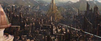 Movie still from “Thor: The Dark World” (2013), directed by Alan Taylor – An aerial view of a city with a mountain in the background; Extreme Wide shot, High angle