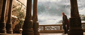 Movie still from “Thor: The Dark World” (2013), directed by Alan Taylor – A view of a cloudy sky from a balcony with pillars; Extreme Wide shot, Low angle