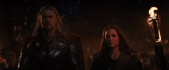 Movie still from “Thor: The Dark World” (2013), directed by Alan Taylor – A man and a woman standing next to each other in the dark; Close Up shot, Low angle