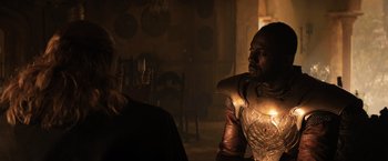 Movie still from “Thor: The Dark World” (2013), directed by Alan Taylor – A man in a leather jacket talking to another man in a leather jacket; Medium shot, Over the shoulder angle