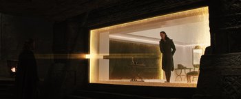 Movie still from “Thor: The Dark World” (2013), directed by Alan Taylor – A woman standing in front of an illuminated window; Wide shot, Low angle