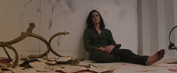 Movie still from “Thor: The Dark World” (2013), directed by Alan Taylor – A man sitting on the floor next to a broken mirror; Medium shot, High angle