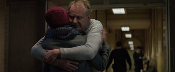 Movie still from “Thor: The Dark World” (2013), directed by Alan Taylor – A man is hugging another man in a room; Close Up shot, Over the shoulder angle