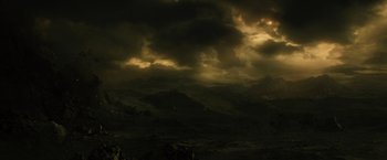 Movie still from “Thor: The Dark World” (2013), directed by Alan Taylor – A dark cloudy sky over a mountainous area; Extreme Wide shot, High angle
