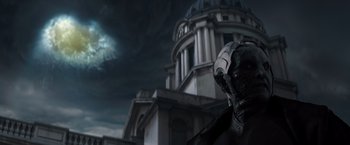 Movie still from “Thor: The Dark World” (2013), directed by Alan Taylor – A statue of a man in front of a large building; Medium shot, Low angle