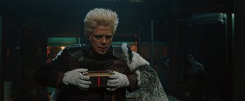 Movie still from “Thor: The Dark World” (2013), directed by Alan Taylor – A man with blonde hair holding a gift box; Close Up shot, Over the shoulder angle
