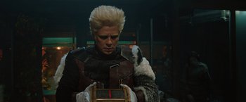 Movie still from “Thor: The Dark World” (2013), directed by Alan Taylor – A man in a costume holding a box and a dog; Close Up shot, Over the shoulder angle