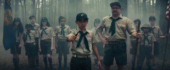 Movie still from “Timmy Failure: Mistakes Were Made” (2020), directed by Tom McCarthy – A group of young boy scouts standing in the woods; Medium shot, Low angle