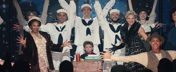 Movie still from “Timmy Failure: Mistakes Were Made” (2020), directed by Tom McCarthy – A group of men standing next to each other on a stage; Wide shot, High angle