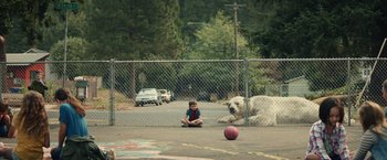 Movie still from “Timmy Failure: Mistakes Were Made” (2020), directed by Tom McCarthy – A boy sitting on the ground next to a dog; Wide shot, Low angle