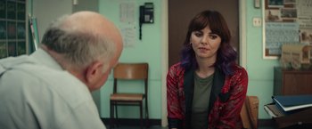 Movie still from “Timmy Failure: Mistakes Were Made” (2020), directed by Tom McCarthy – A woman sitting in front of an older man in a room; Medium shot, Over the shoulder angle
