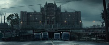 Movie still from “Timmy Failure: Mistakes Were Made” (2020), directed by Tom McCarthy – A group of buses parked in front of a building; Extreme Wide shot, Low angle