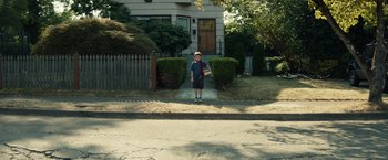Movie still from “Timmy Failure: Mistakes Were Made” (2020), directed by Tom McCarthy – A young boy standing in front of a house; Extreme Wide shot, High angle