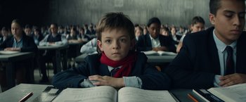 Movie still from “Timmy Failure: Mistakes Were Made” (2020), directed by Tom McCarthy – A boy sitting at a desk in a classroom; Medium shot, Low angle