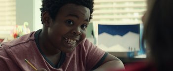 Movie still from “Timmy Failure: Mistakes Were Made” (2020), directed by Tom McCarthy – A person with a smile on their face; Close Up shot, Over the shoulder angle