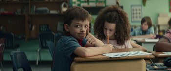 Movie still from “Timmy Failure: Mistakes Were Made” (2020), directed by Tom McCarthy – A boy and a girl sitting at a desk; Medium shot, Low angle
