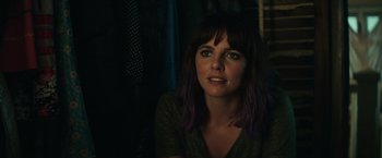Movie still from “Timmy Failure: Mistakes Were Made” (2020), directed by Tom McCarthy – A woman with purple hair sitting in the dark; Close Up shot, Over the shoulder angle