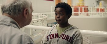 Movie still from “Timmy Failure: Mistakes Were Made” (2020), directed by Tom McCarthy – A young boy talking to a man in a room; Close Up shot, Over the shoulder angle