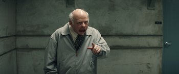 Movie still from “Timmy Failure: Mistakes Were Made” (2020), directed by Tom McCarthy – An older man in a jacket and tie pointing to the side; Medium shot, Over the shoulder angle
