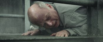 Movie still from “Timmy Failure: Mistakes Were Made” (2020), directed by Tom McCarthy – An older man leaning on a railing with his head down; Close Up shot, Overhead angle