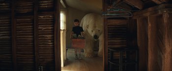 Movie still from “Timmy Failure: Mistakes Were Made” (2020), directed by Tom McCarthy – A young boy standing next to a large polar bear; Wide shot, Low angle