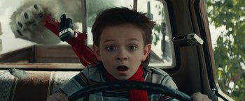 Movie still from “Timmy Failure: Mistakes Were Made” (2020), directed by Tom McCarthy – A young boy sitting in the driver's seat of a car; Close Up shot, Over the shoulder angle