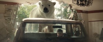 Movie still from “Timmy Failure: Mistakes Were Made” (2020), directed by Tom McCarthy – A white polar bear standing next to a car window; Wide shot, Low angle