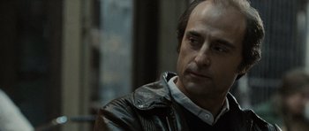 Movie still from “Tinker Tailor Soldier Spy” (2011), directed by Tomas Alfredson – A person wearing a leather jacket; Close Up shot, Over the shoulder angle