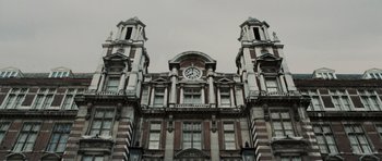Movie still from “Tinker Tailor Soldier Spy” (2011), directed by Tomas Alfredson – A large building with a clock on the top of it; Extreme Wide shot, Low angle