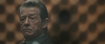 Movie still from “Tinker Tailor Soldier Spy” (2011), directed by Tomas Alfredson – An old man with a beard and a mustache; Close Up shot, Over the shoulder angle