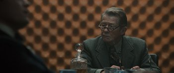 Movie still from “Tinker Tailor Soldier Spy” (2011), directed by Tomas Alfredson – An older man sitting at a dinner table; Close Up shot, Over the shoulder angle
