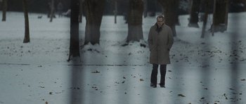 Movie still from “Tinker Tailor Soldier Spy” (2011), directed by Tomas Alfredson – A man standing in the middle of a snow covered park; Wide shot, Over the shoulder angle